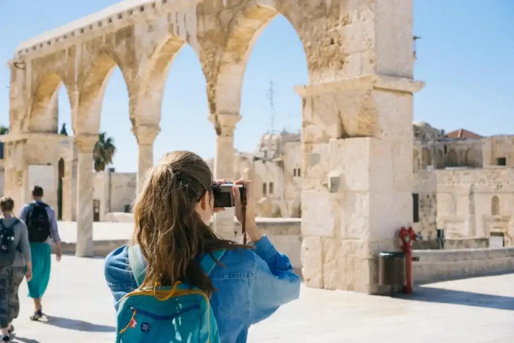 a woman taking a picture of a building