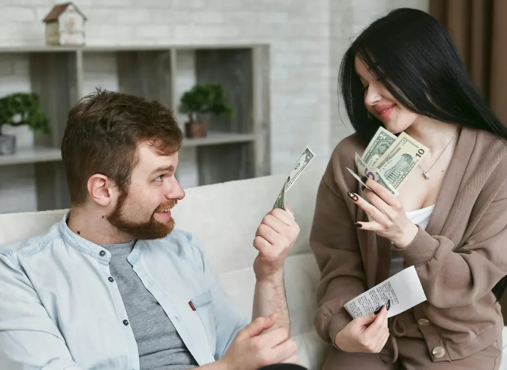 a man and woman holding money