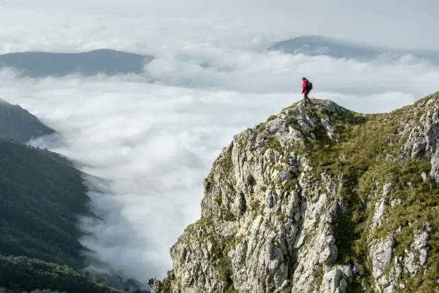 a person standing on top of the mountain 