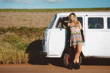 girl standing on road with van