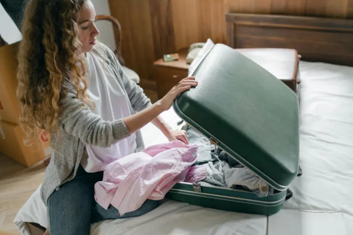 a girl packing suitcase