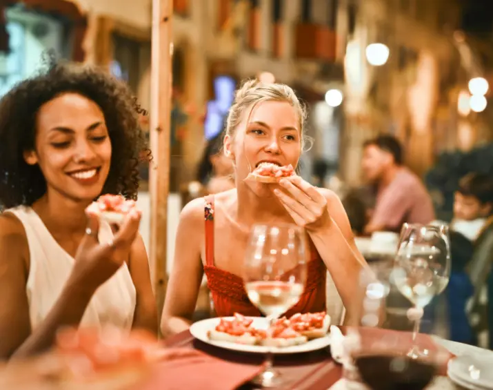 two girls eating in restaurant