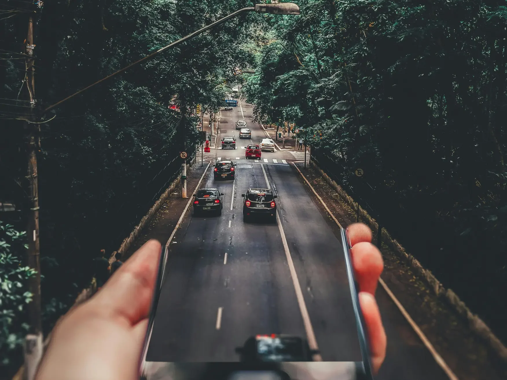 a person taking a picture of a road with cars